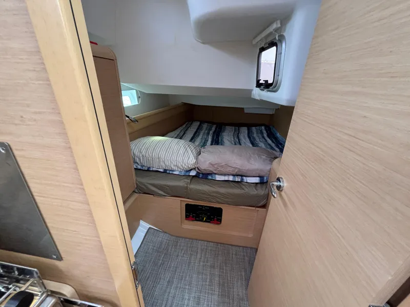 Slide: The Image of Cozy cabin interior of 2019 Jeanneau Sun Odyssey 419 sailboat with bed and window. - 17