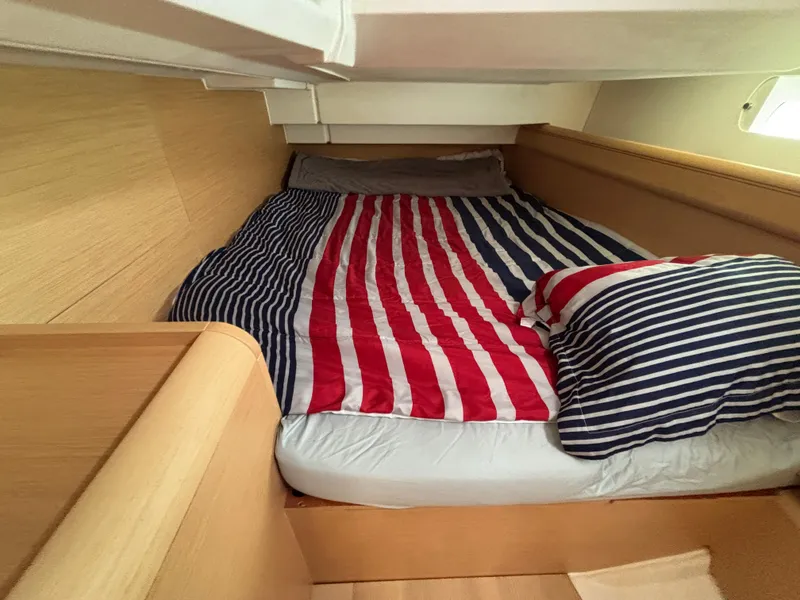 Slide: The Image of Cozy cabin bed with striped bedding in 2019 Jeanneau Sun Odyssey 419 sailboat. - 21