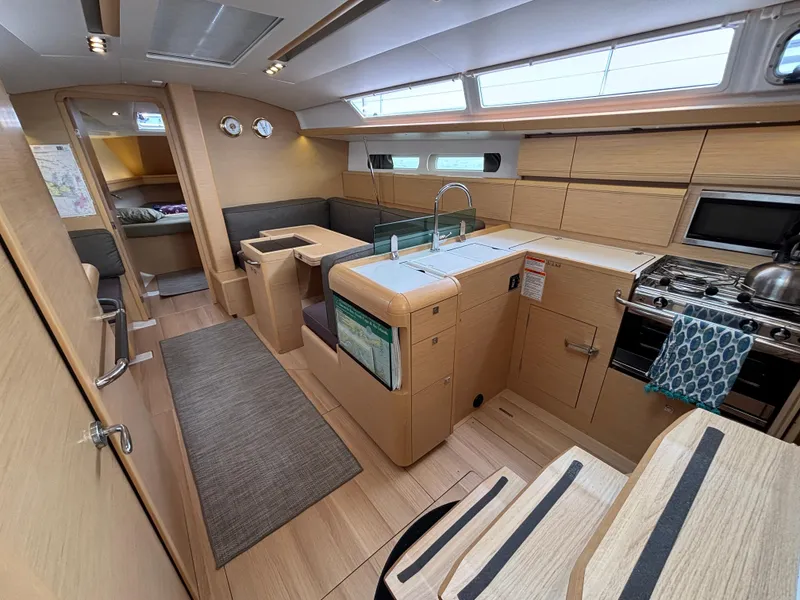Slide: The Image of Interior of 2019 Jeanneau Sun Odyssey 419 yacht, featuring modern kitchen and seating area. - 23
