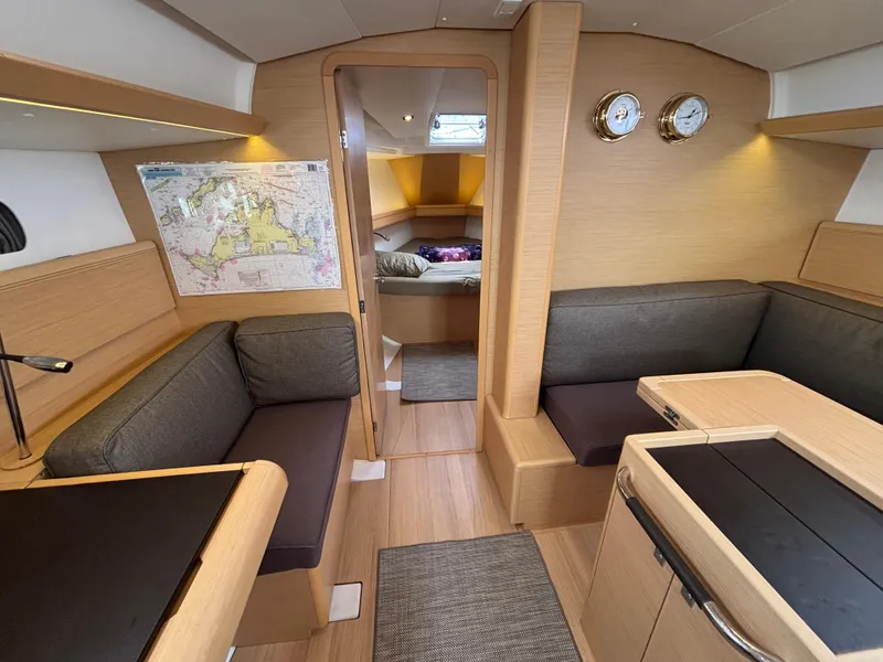 Slide: The Image of Interior of 2019 Jeanneau Sun Odyssey 419 sailboat, featuring cozy seating and nautical decor. - 27