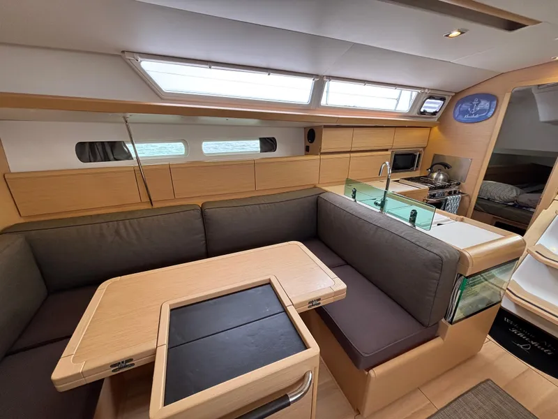 Slide: The Image of Interior of 2019 Jeanneau Sun Odyssey 419 yacht with modern kitchen and seating area. - 28