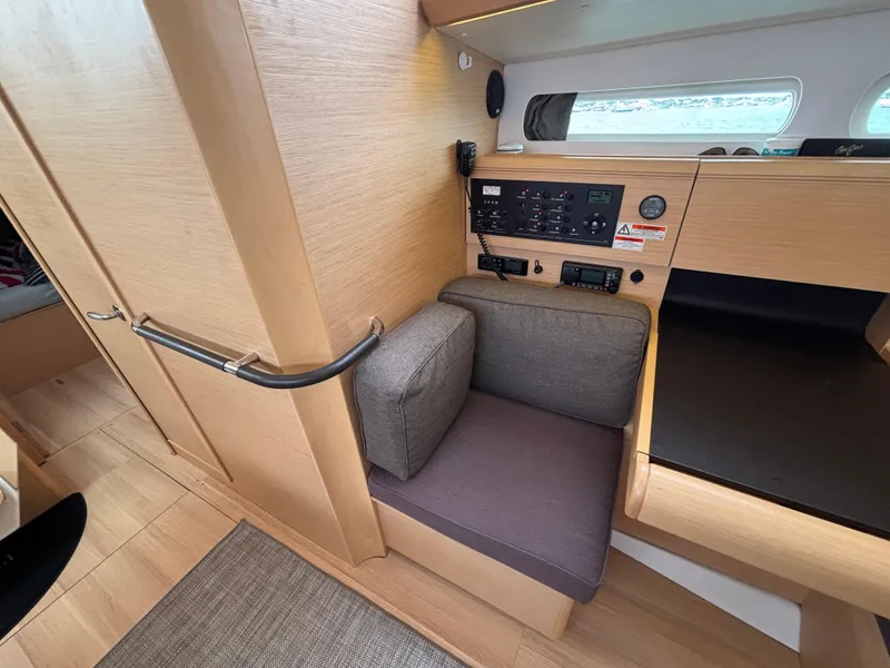 Slide: The Image of Interior of 2019 Jeanneau Sun Odyssey 419 yacht with navigation panel and seating area. - 29