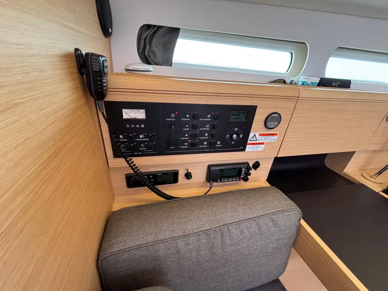 Slide: The Image of Interior control panel of 2019 Jeanneau Sun Odyssey 419 sailboat, featuring navigation and communication equipment. - 30
