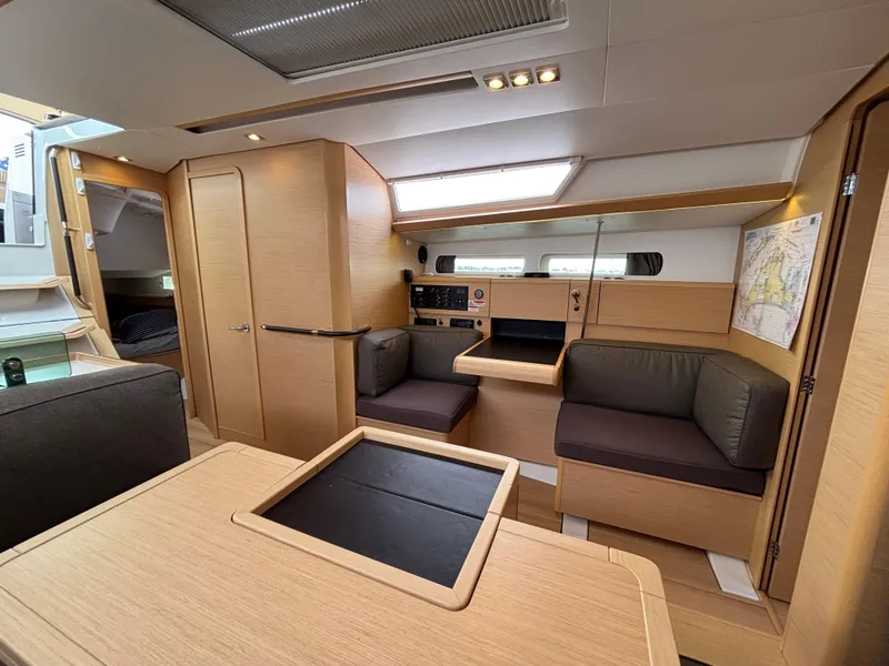 Slide: The Image of Interior of 2019 Jeanneau Sun Odyssey 419 yacht, featuring modern wood finish and seating area. - 31