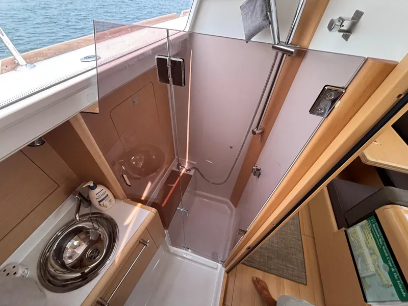 Slide: The Image of Interior of 2019 Jeanneau Sun Odyssey 419 yacht, featuring compact bathroom with shower and sink. - 33