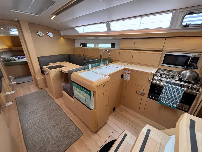 Slide: The Image of Interior of 2019 Jeanneau Sun Odyssey 419 sailboat with modern kitchen and seating area. - 35