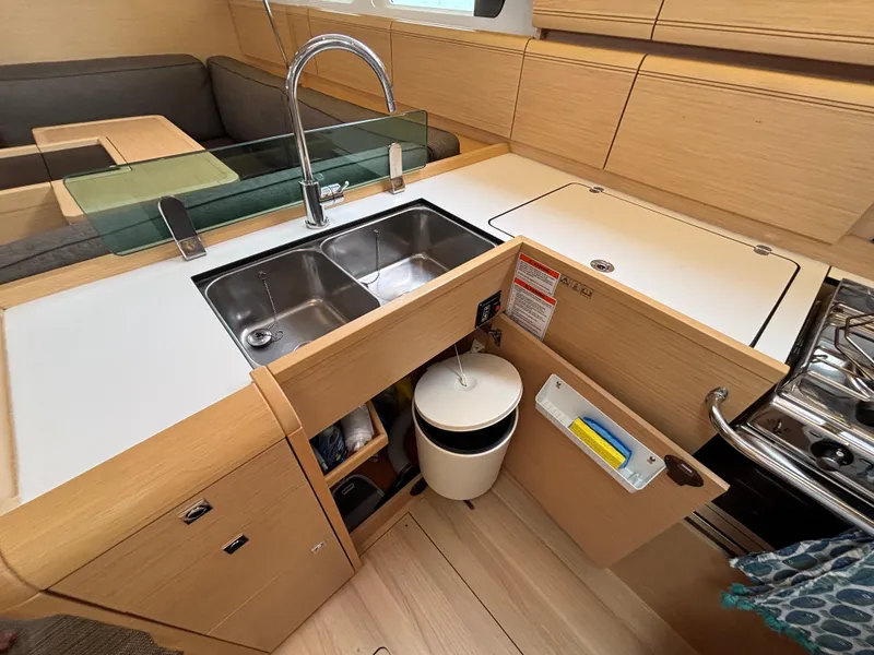 Slide: The Image of Modern kitchen in 2019 Jeanneau Sun Odyssey 419 yacht with dual sinks and ample storage. - 36