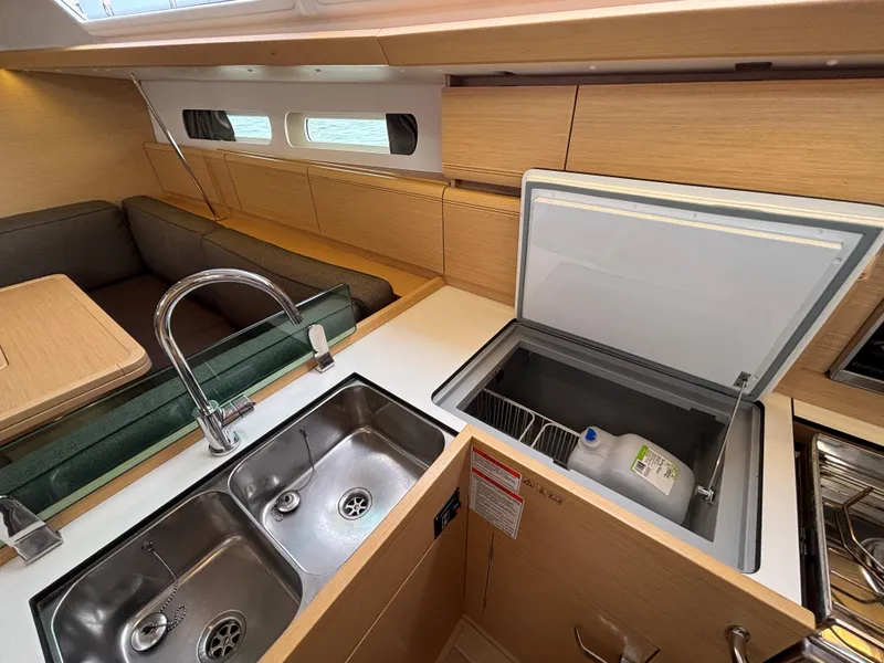 Slide: The Image of Interior of 2019 Jeanneau Sun Odyssey 419 yacht, featuring kitchen sink and open fridge. - 37