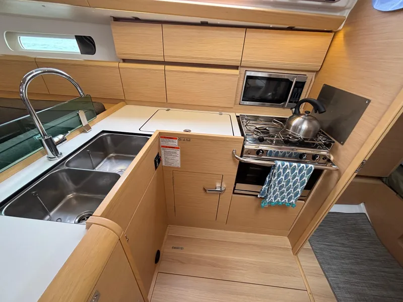 Slide: The Image of Modern kitchen in 2019 Jeanneau Sun Odyssey 419 yacht with stove, sink, and microwave. - 39