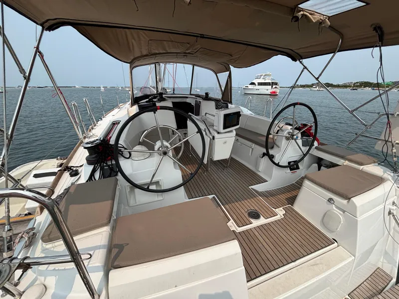 Slide: The Image of 2019 Jeanneau Sun Odyssey 419 sailboat cockpit with dual steering wheels and navigation equipment. - 4
