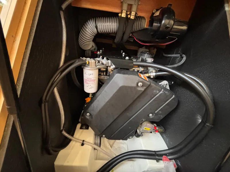 Slide: The Image of Engine compartment of a 2019 Jeanneau Sun Odyssey 419 sailboat, showcasing mechanical components. - 40