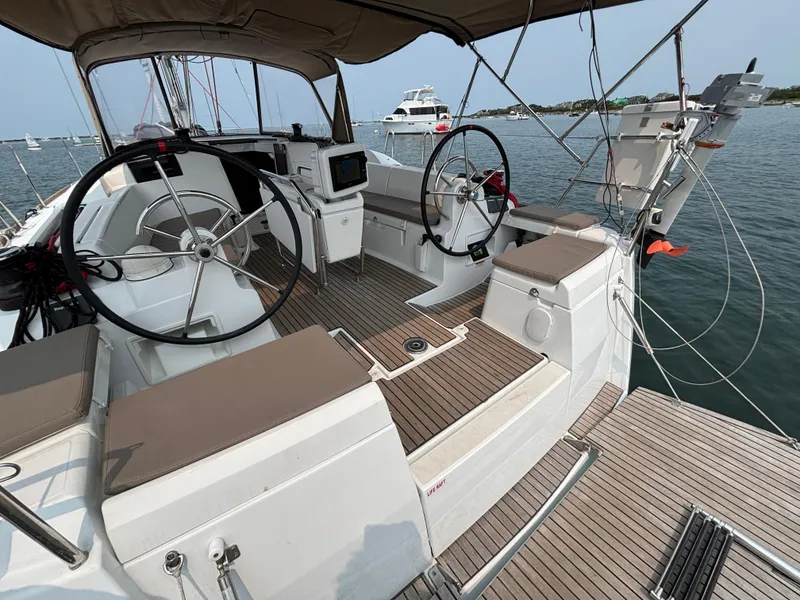 Slide: The Image of 2019 Jeanneau Sun Odyssey 419 sailboat cockpit with dual steering wheels and teak decking. - 42