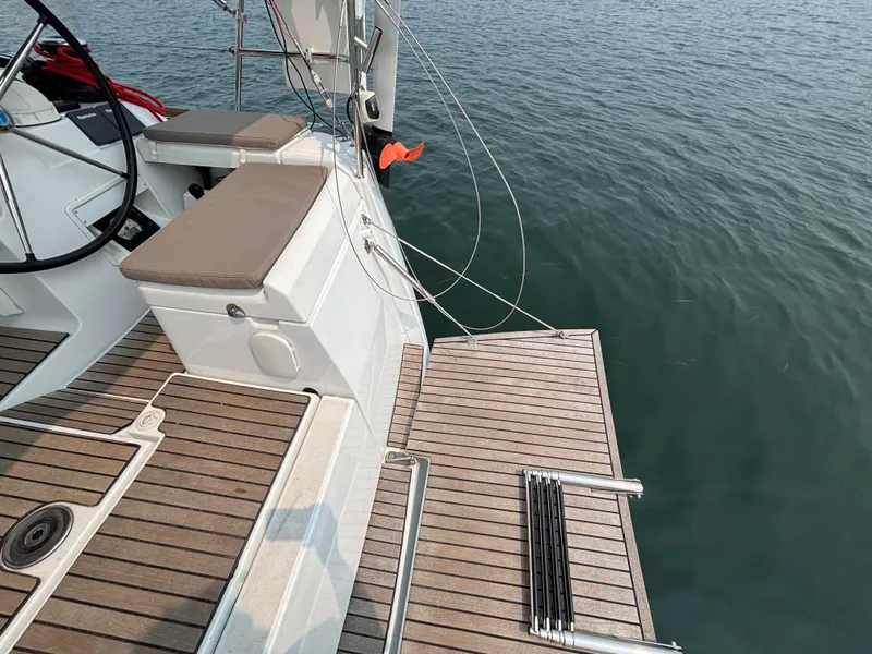 Slide: The Image of 2019 Jeanneau Sun Odyssey 419 yacht deck with wooden finish and water view. - 43