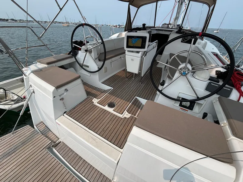 Slide: The Image of 2019 Jeanneau Sun Odyssey 419 yacht cockpit with dual steering wheels and navigation equipment. - 44