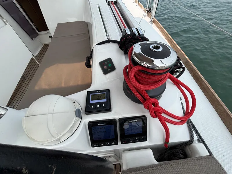 Slide: The Image of Cockpit of 2019 Jeanneau Sun Odyssey 419 with winch, red rope, and navigation instruments. - 46