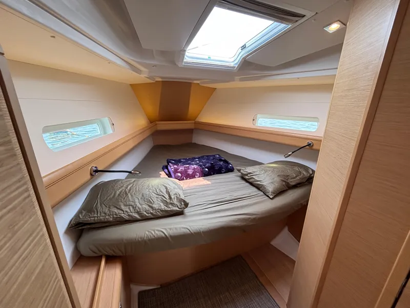 Slide: The Image of Cozy cabin interior of 2019 Jeanneau Sun Odyssey 419 sailboat with skylight and bedding. - 6