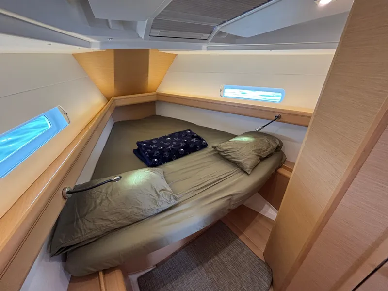 Slide: The Image of Cozy cabin interior of 2019 Jeanneau Sun Odyssey 419 sailboat with bed and porthole. - 9