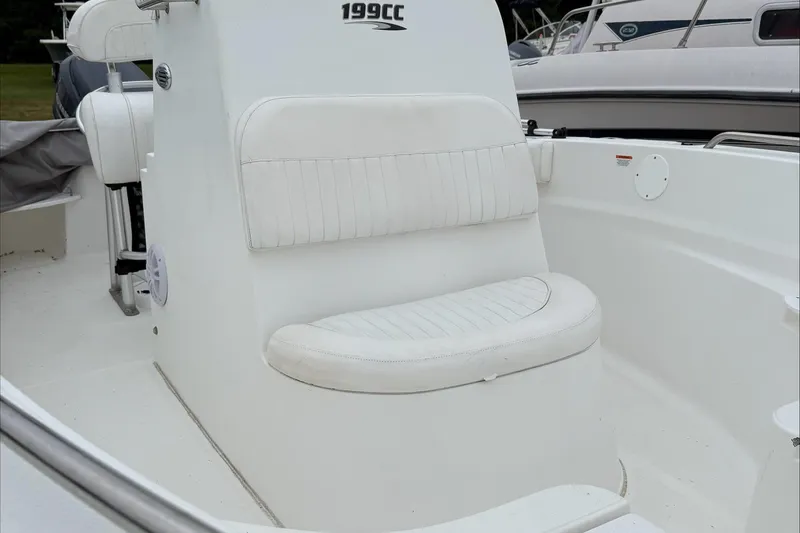 Slide: The Image of 2013 Sea Fox 199 Commander boat interior with white seating and console. - 2