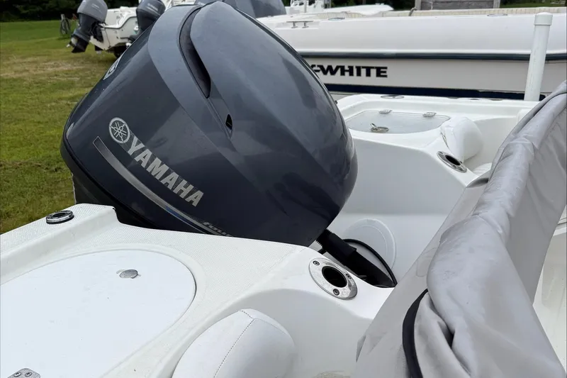 Slide: The Image of 2013 Sea Fox 199 Commander with Yamaha outboard engine, parked on grass. - 4