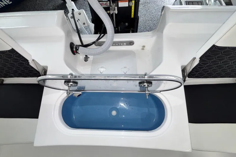 Slide: The Image of 2026 Tidewater 2110 Bay Max boat livewell with open lid and plumbing details. - 10