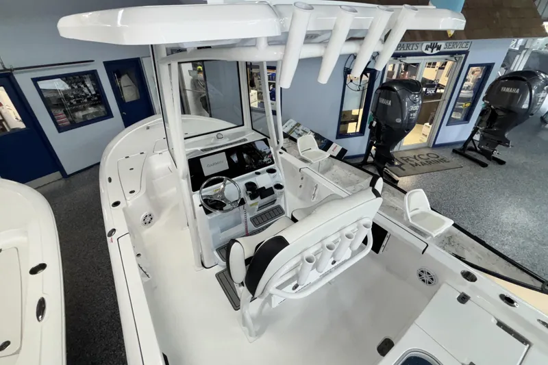 Slide: The Image of 2026 Tidewater 2110 Bay Max boat interior with steering console and seating. - 11