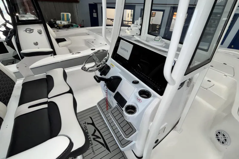 Slide: The Image of 2026 Tidewater 2110 Bay Max boat interior with Garmin navigation and sleek seating. - 17