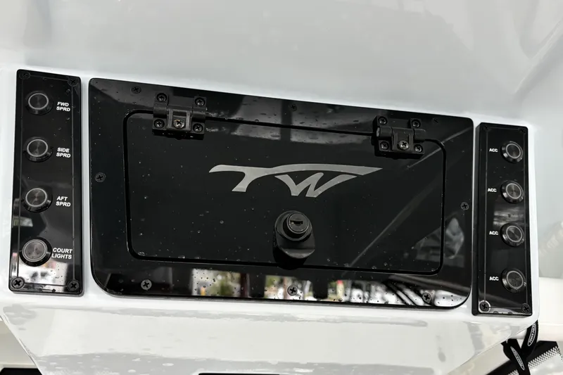 Slide: The Image of Control panel of 2026 Tidewater 2110 Bay Max boat with switches and logo. - 19