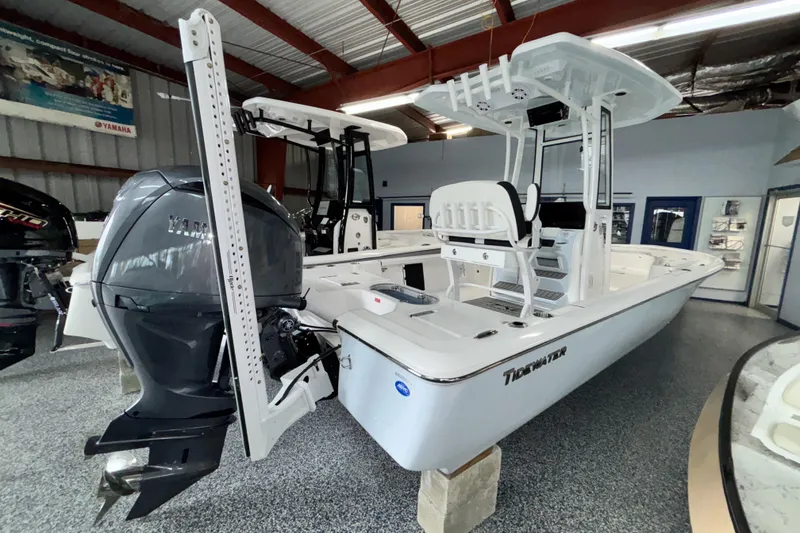Slide: The Image of 2026 Tidewater 2110 Bay Max boat in showroom, featuring Yamaha outboard motor. - 2