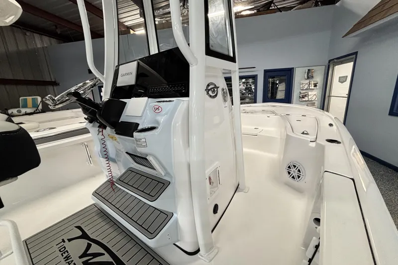 Slide: The Image of 2026 Tidewater 2110 Bay Max boat interior with steering console and seating area. - 21