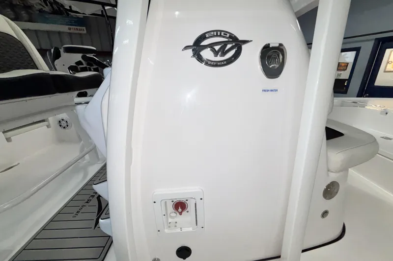 Slide: The Image of 2026 Tidewater 2110 Bay Max boat interior, featuring fresh water access and seating. - 22