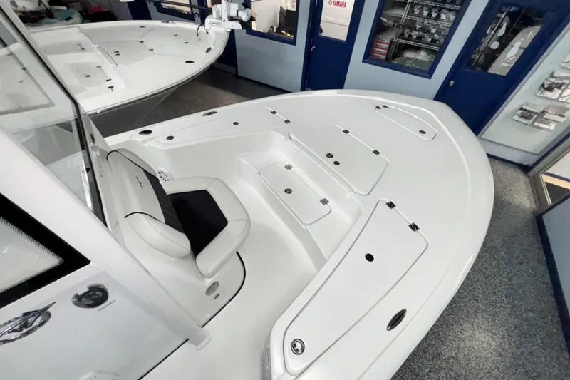 Slide: The Image of 2026 Tidewater 2110 Bay Max boat interior with seating and storage compartments. - 25