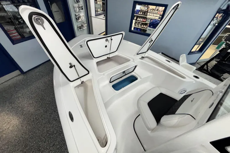 Slide: The Image of 2026 Tidewater 2110 Bay Max boat interior with open storage compartments and seating. - 27