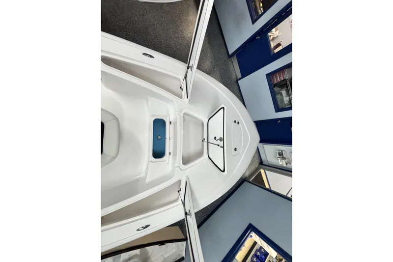 Slide: The Image of 2026 Tidewater 2110 Bay Max boat interior, showcasing spacious deck and storage compartments. - 30