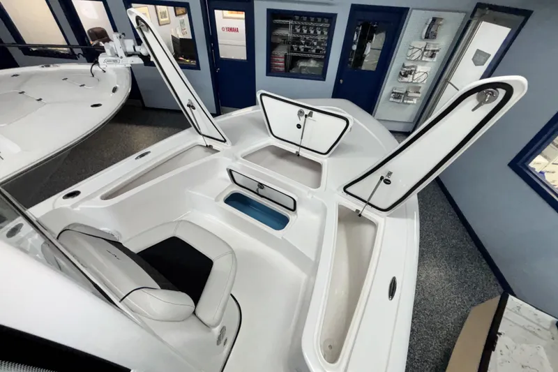 Slide: The Image of 2026 Tidewater 2110 Bay Max boat interior with open storage compartments. - 31