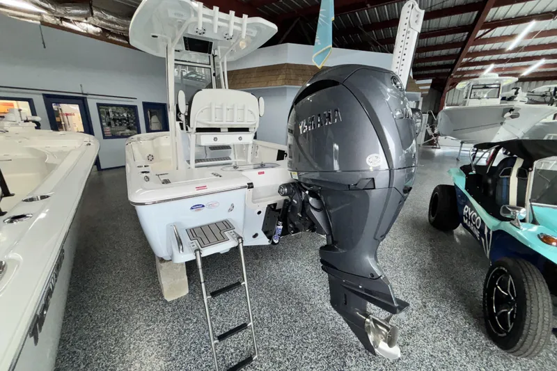 Slide: The Image of 2026 Tidewater 2110 Bay Max boat with Yamaha outboard motor in showroom. - 6
