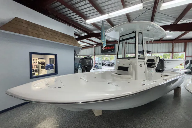 Slide: The Image of 2026 Tidewater 2110 Bay Max boat displayed in a showroom with Yamaha engine. - 7