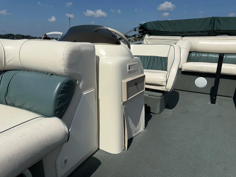 Slide: The Image of Interior of 2000 Playbuoy Yachtsman 21 pontoon boat with cushioned seating. - 10