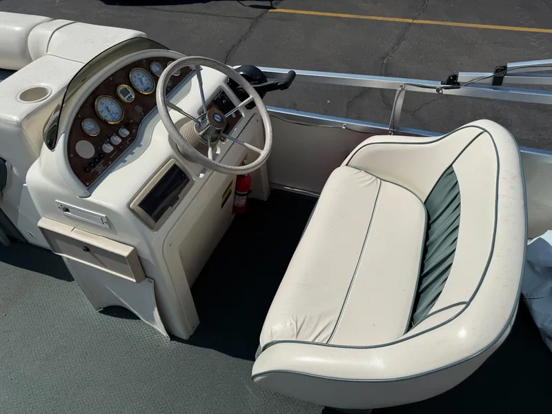 Slide: The Image of Captain's seat and dashboard of a 2000 Playbuoy Yachtsman 21 pontoon boat. - 13