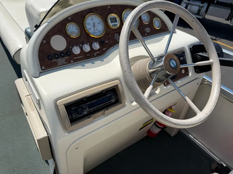 Slide: The Image of Steering console of 2000 Playbuoy Yachtsman 21 with gauges and controls. - 14