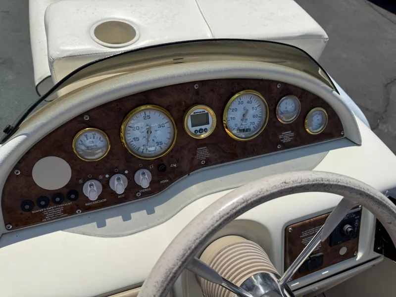 Slide: The Image of Dashboard of a 2000 Playbuoy Yachtsman 21 boat with gauges and controls. - 15