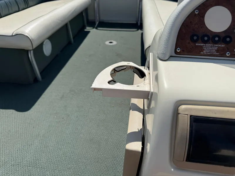 Slide: The Image of Interior of 2000 Playbuoy Yachtsman 21 with cup holder and seating. - 19