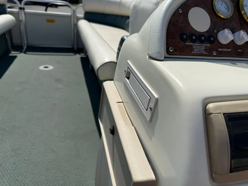 Slide: The Image of Interior of a 2000 Playbuoy Yachtsman 21 pontoon boat with seating and control panel. - 20