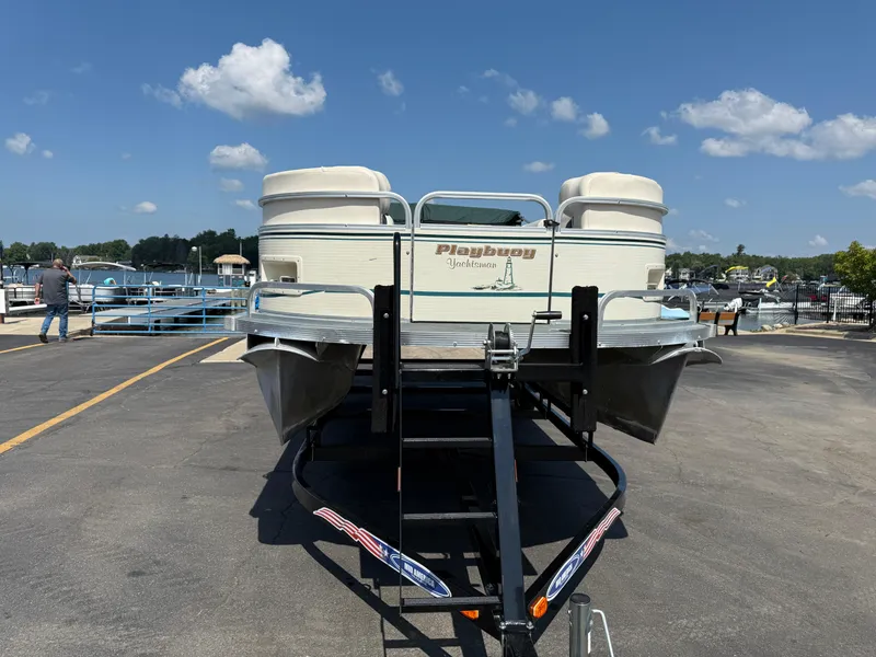 Slide: The Image of Playbuoy Yachtsman 21 pontoon boat on trailer, sunny marina background, 2000 model. - 4