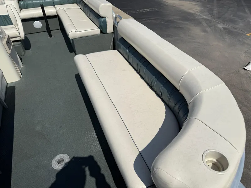 Slide: The Image of Interior of 2000 Playbuoy Yachtsman 21 pontoon boat with white seating and carpeted floor. - 9