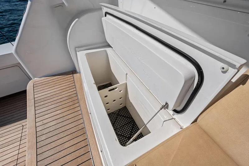 Slide: The Image of Open storage compartment on 2017 Viking 62 Enclosed Bridge yacht with teak flooring. - 15