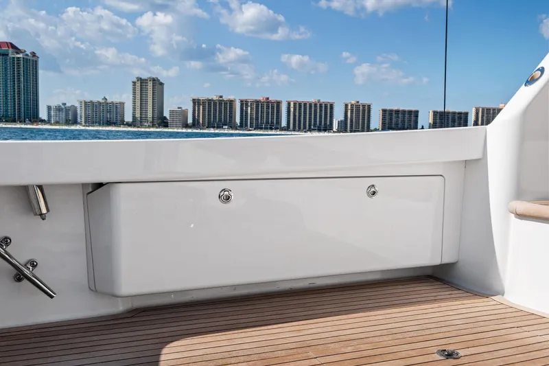 Slide: The Image of 2017 Viking 62 Enclosed Bridge yacht deck with city skyline in background. - 19