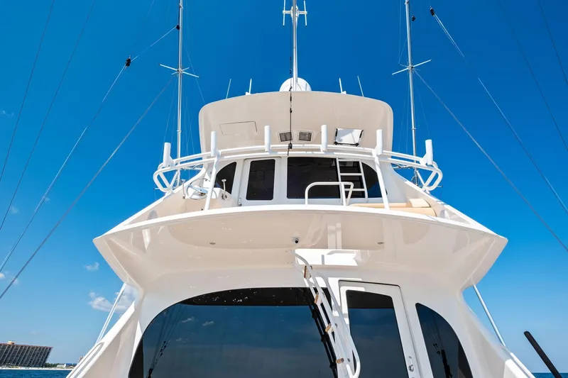 Slide: The Image of 2017 Viking 62 Enclosed Bridge yacht against clear blue sky. - 24