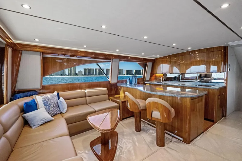 Slide: The Image of Luxurious interior of 2017 Viking 62 Enclosed Bridge yacht with elegant seating and kitchen area. - 26