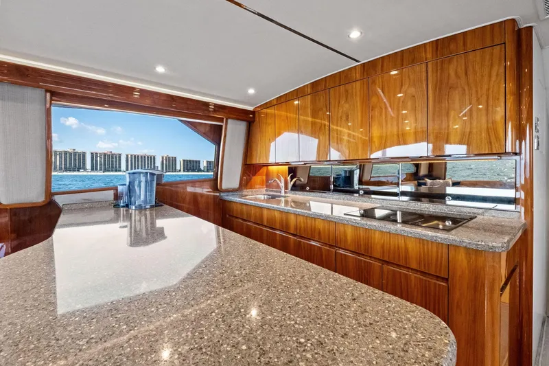 Slide: The Image of Luxurious kitchen interior of 2017 Viking 62 Enclosed Bridge yacht with ocean view. - 27