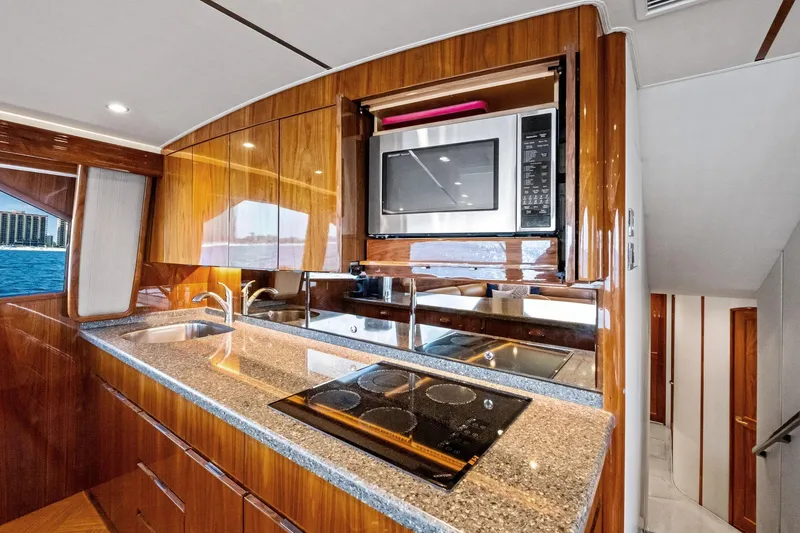 Slide: The Image of Luxurious kitchen interior of 2017 Viking 62 Enclosed Bridge yacht with modern appliances. - 28